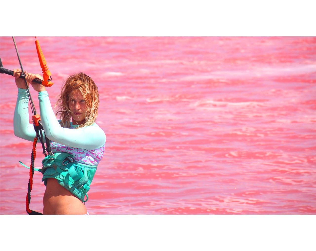 Kiteboarding on a pink lake