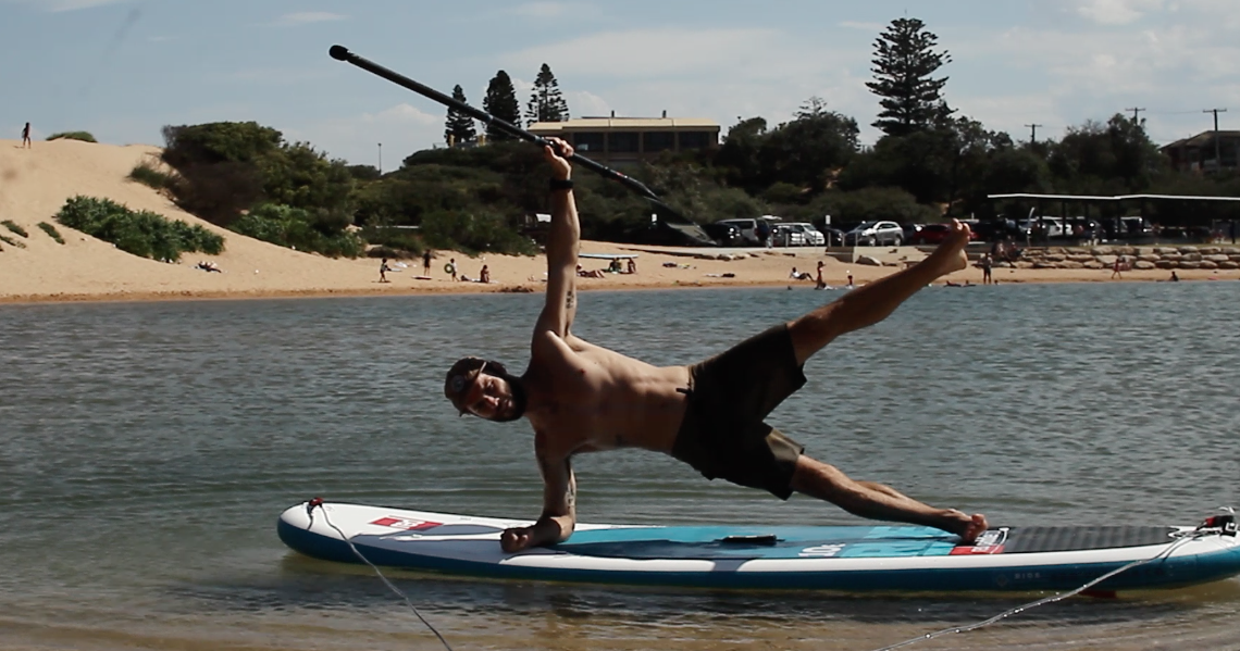 Side plank on Red Paddle Co board