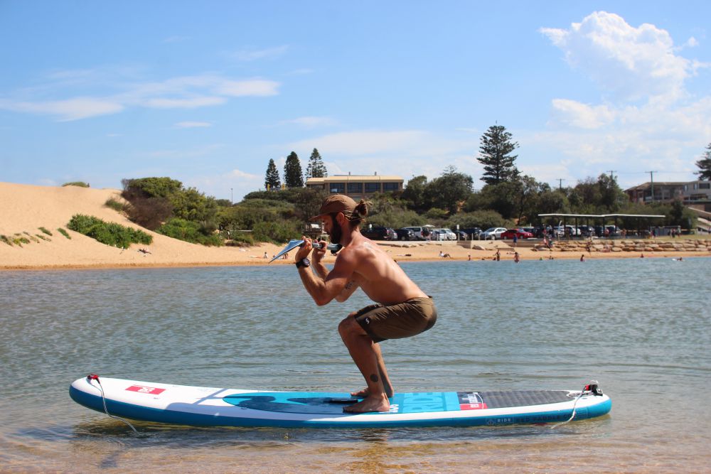 Squats on inflatable stand up paddle board