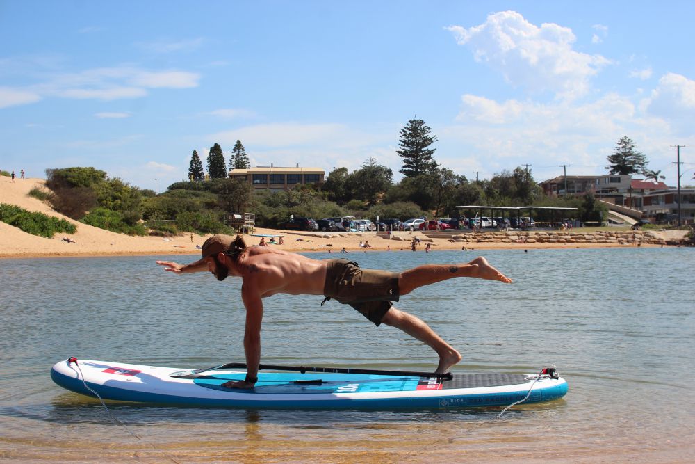 Superman plank on Red Paddle Co board